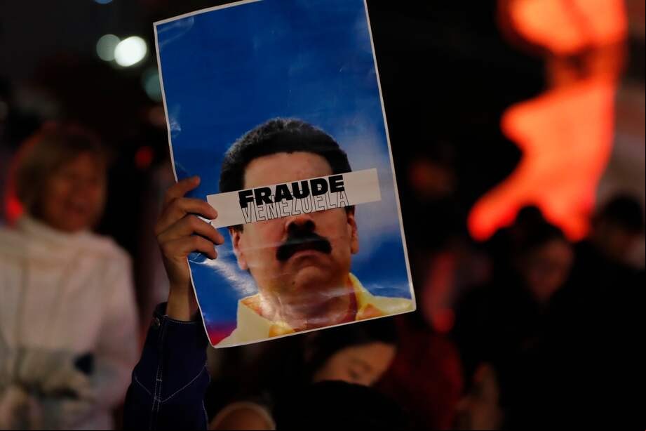 Una persona sostiene un cartel que dice "Fraude Venezuela" durante una protesta para exigir el conteo de votos que favorecen al candidato opositor Edmundo González, tras las votaciones del pasado 28 de julio.